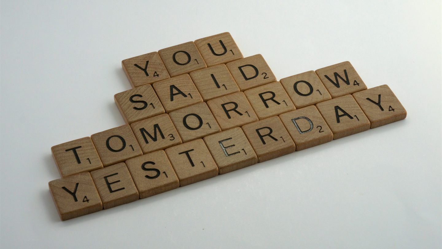 Wooden letter tiles spelling "You said tomorrow yesterday"